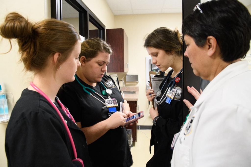 nursing students using calculator on phone