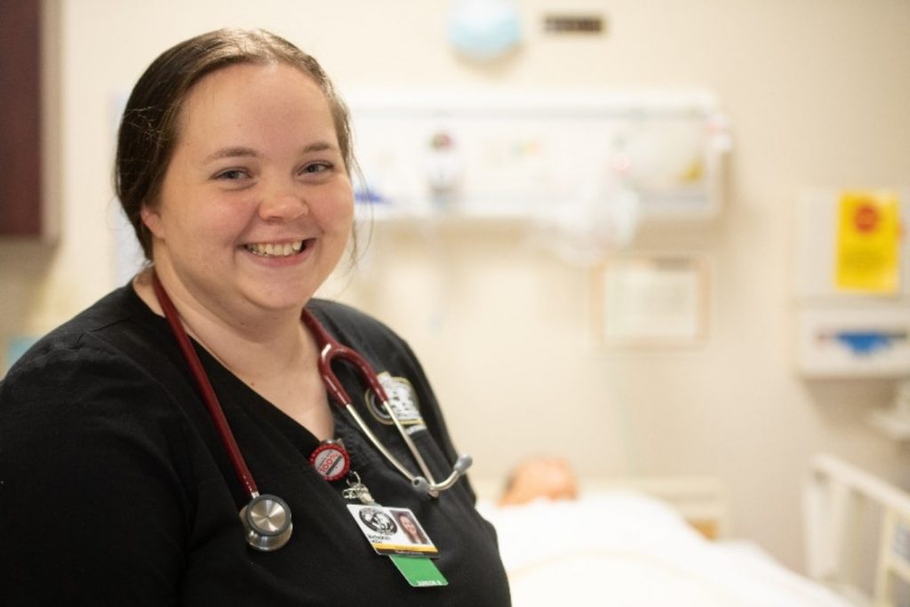 Harding ABSN student close up smiling in stethoscope