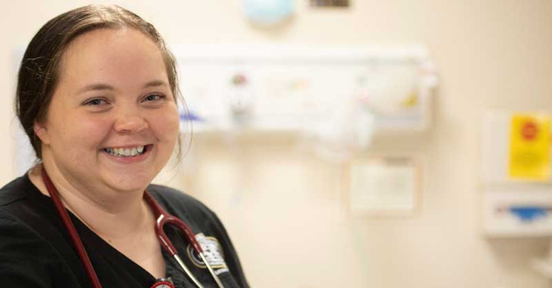 Harding ABSN student standing in lab smiling