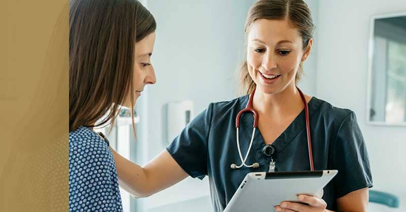 Nursing holding patient chart for patient