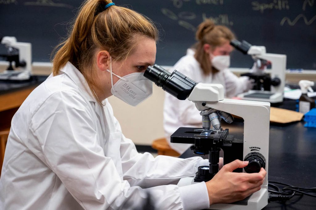 Student looking through microscope