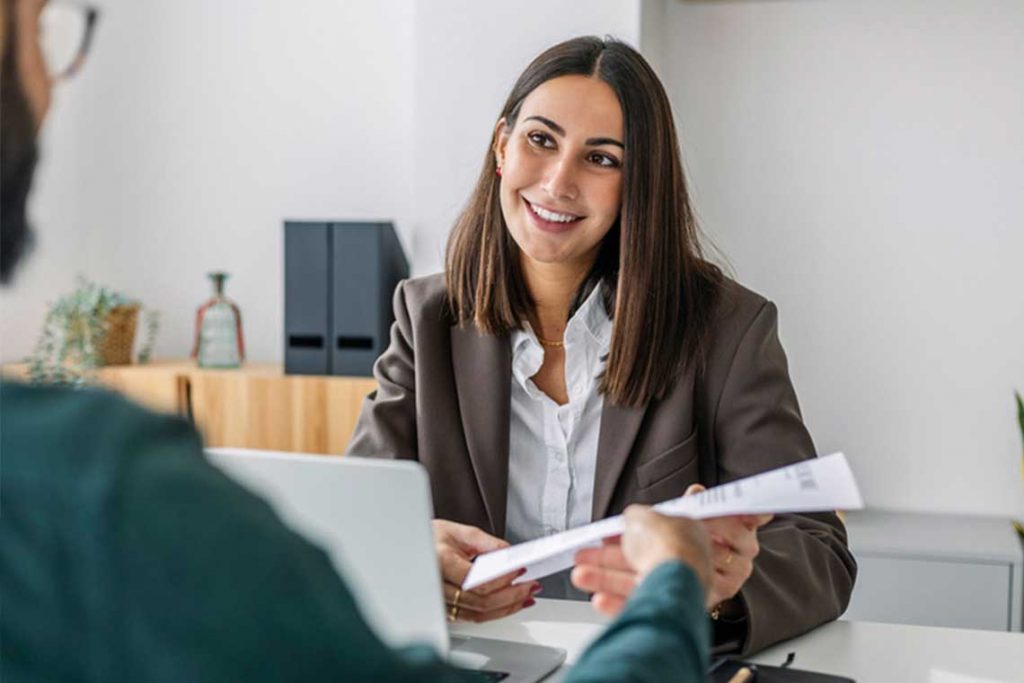 woman sitting in interview with resumÃ©