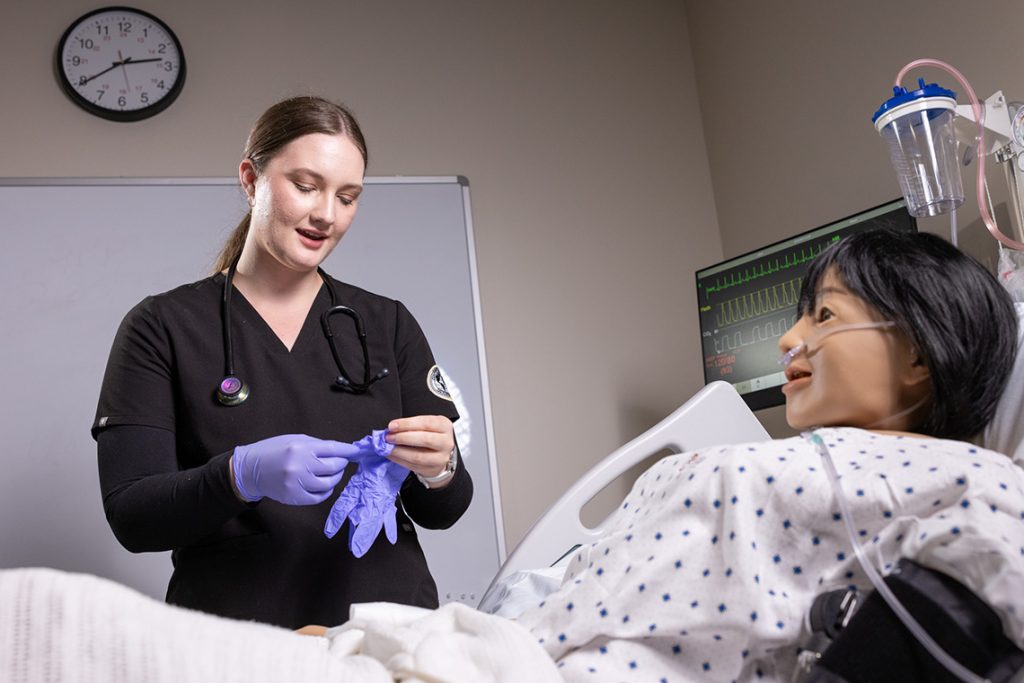 nursing student putting on gloves