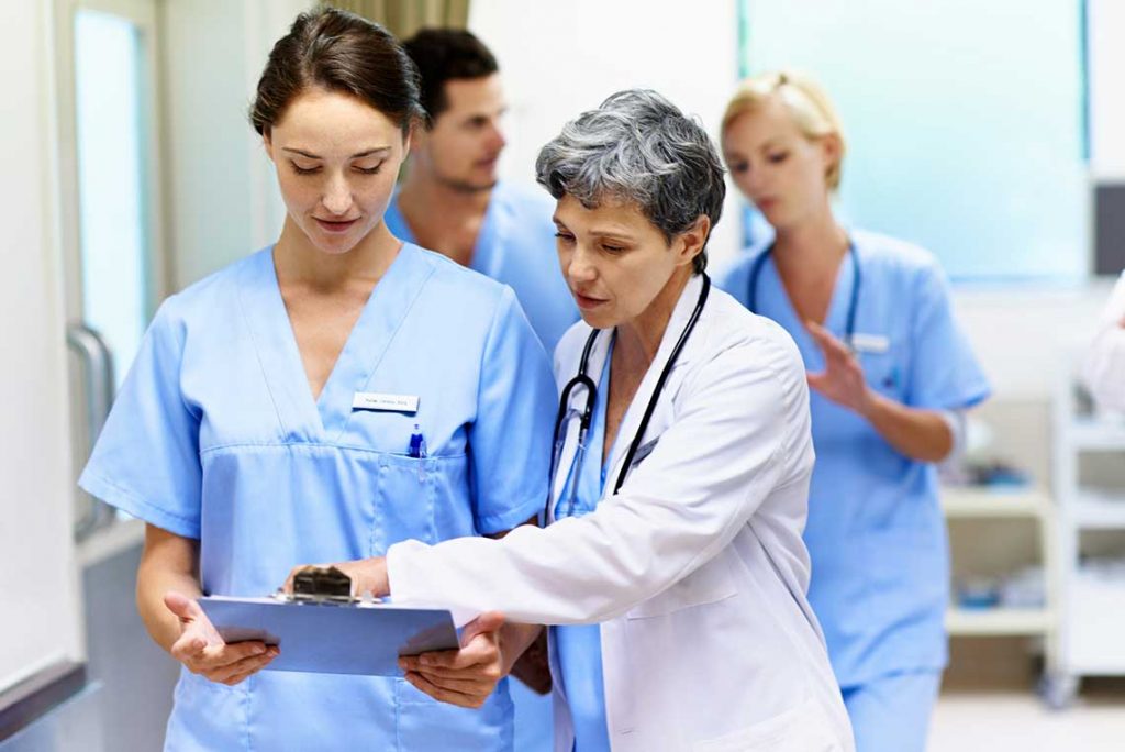 nurse with nurse manager pointing to clipboard
